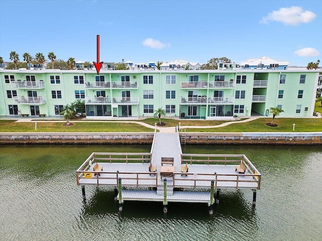 dock area with a yard and a water view