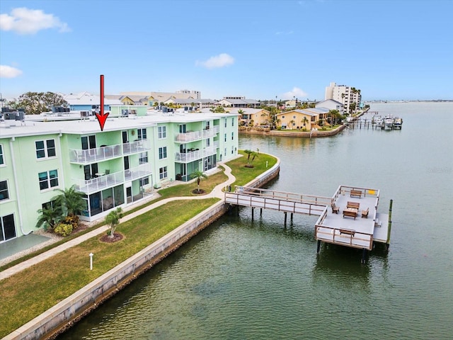 view of dock featuring a yard and a water view