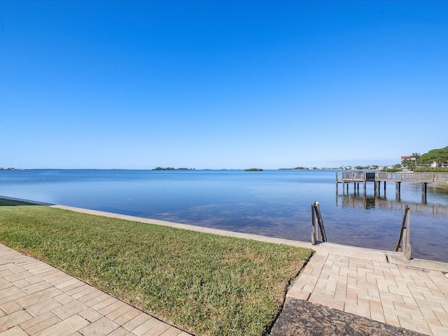 view of dock featuring a yard and a water view