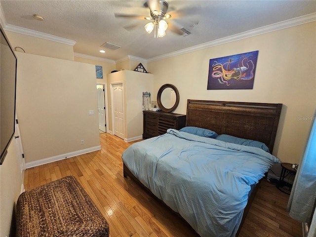 bedroom featuring ceiling fan, wood-type flooring, and ornamental molding