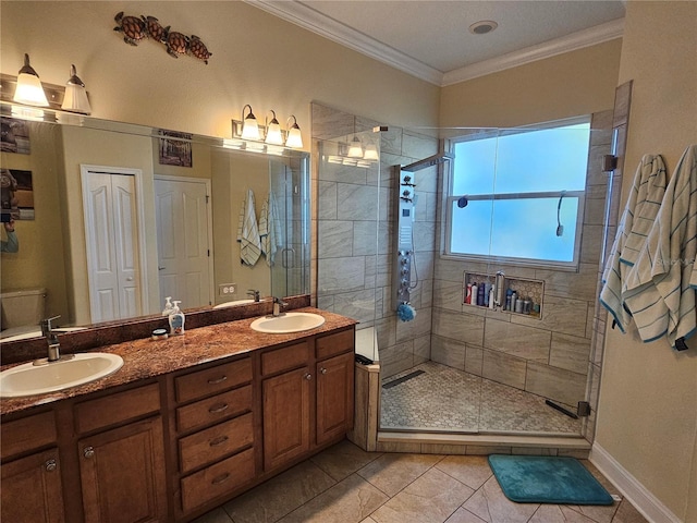 bathroom with tile patterned floors, a shower with door, vanity, and ornamental molding