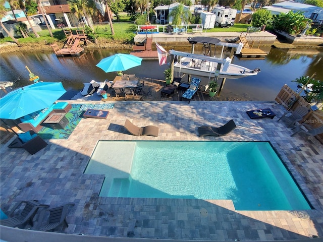 view of swimming pool with a water view