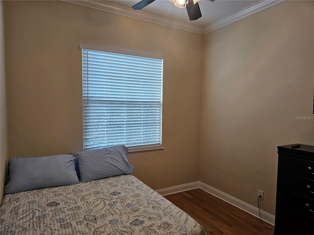 bedroom featuring ornamental molding, ceiling fan, and dark wood-type flooring