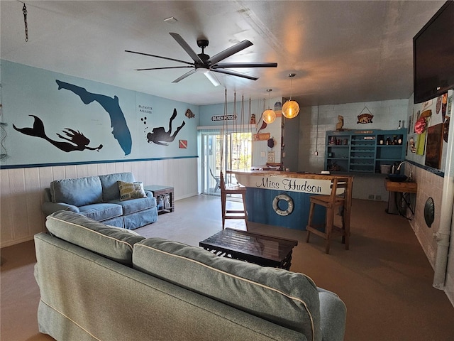 living room featuring ceiling fan and concrete floors