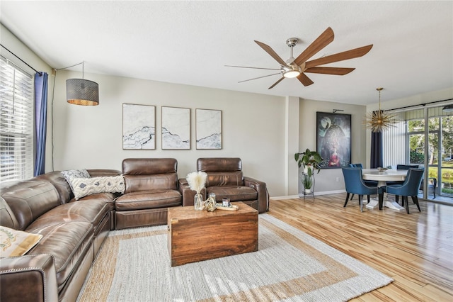 living room featuring ceiling fan, a healthy amount of sunlight, and light hardwood / wood-style floors