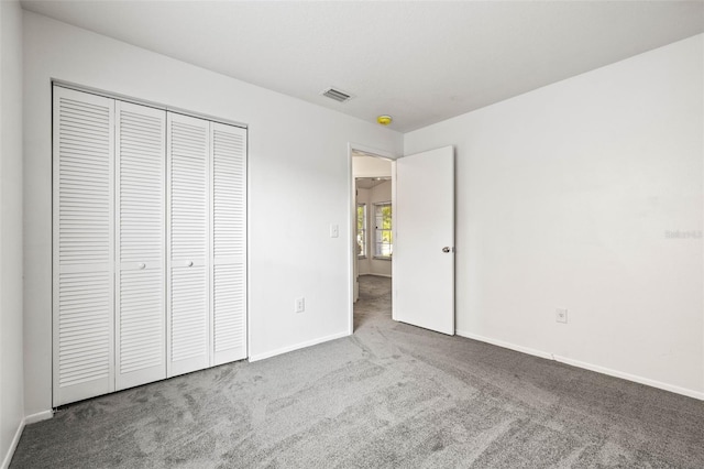 unfurnished bedroom featuring a closet and carpet floors