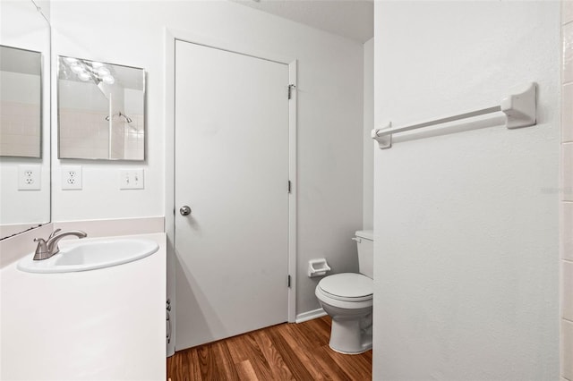 bathroom featuring hardwood / wood-style flooring, vanity, and toilet