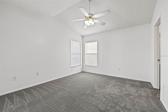 carpeted spare room featuring vaulted ceiling and ceiling fan