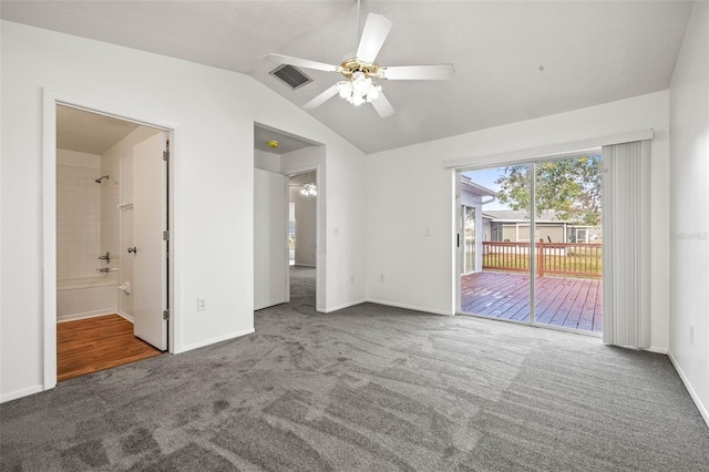 interior space featuring ensuite bathroom, vaulted ceiling, ceiling fan, access to exterior, and carpet floors