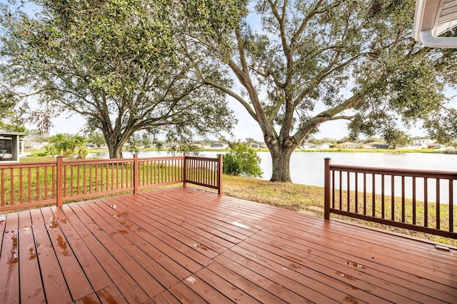 wooden deck featuring a water view