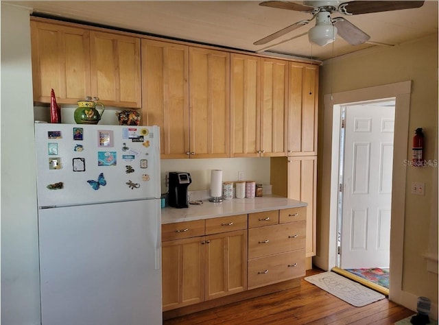 kitchen featuring light brown cabinetry, ceiling fan, hardwood / wood-style floors, and white refrigerator