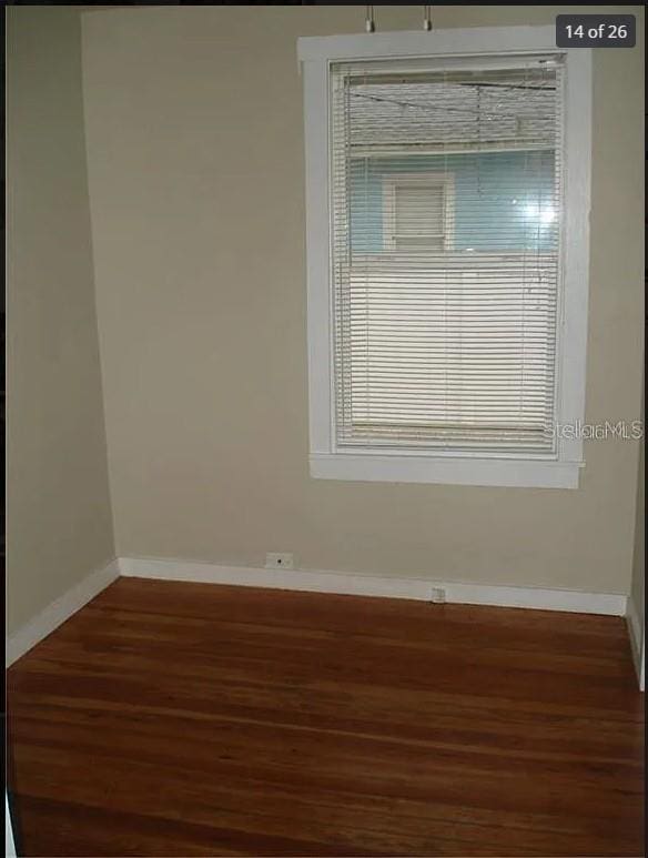 spare room featuring dark hardwood / wood-style floors