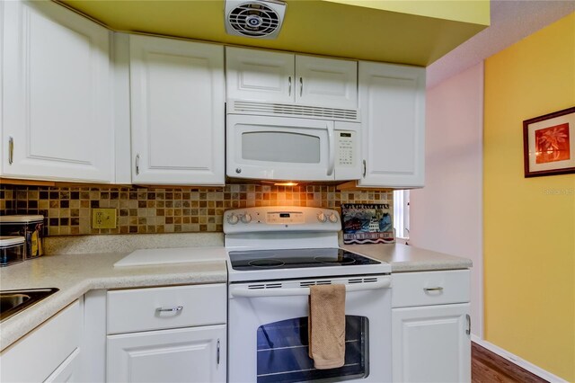 kitchen with white cabinets, white appliances, and tasteful backsplash