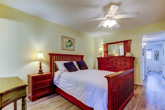 bedroom with ceiling fan and light hardwood / wood-style floors