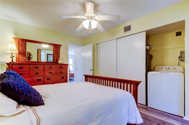 bedroom featuring ceiling fan, light hardwood / wood-style floors, and washer / dryer