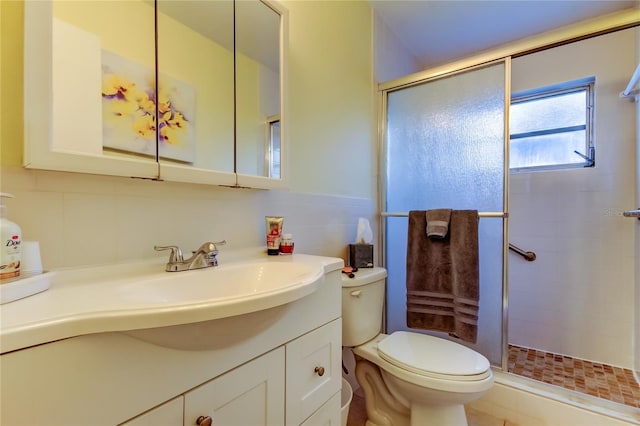 bathroom featuring vanity, toilet, and walk in shower