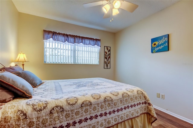 bedroom with ceiling fan and hardwood / wood-style floors