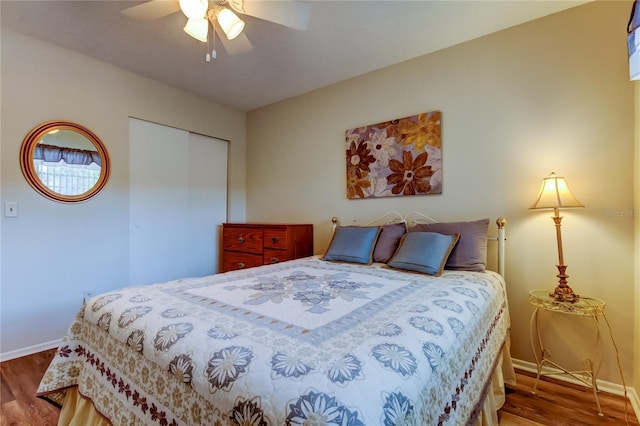 bedroom featuring wood-type flooring, a closet, and ceiling fan