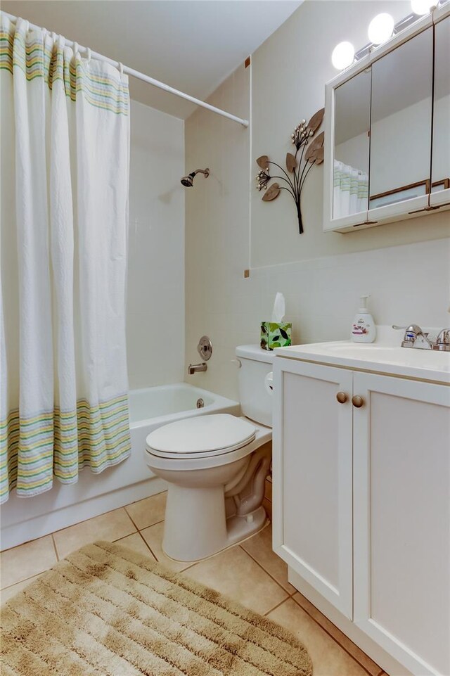 full bathroom with tile patterned flooring, vanity, toilet, and shower / bathtub combination with curtain