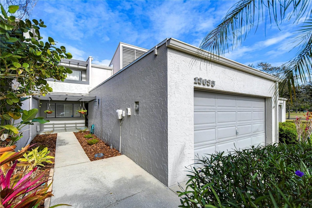 view of side of home featuring a garage