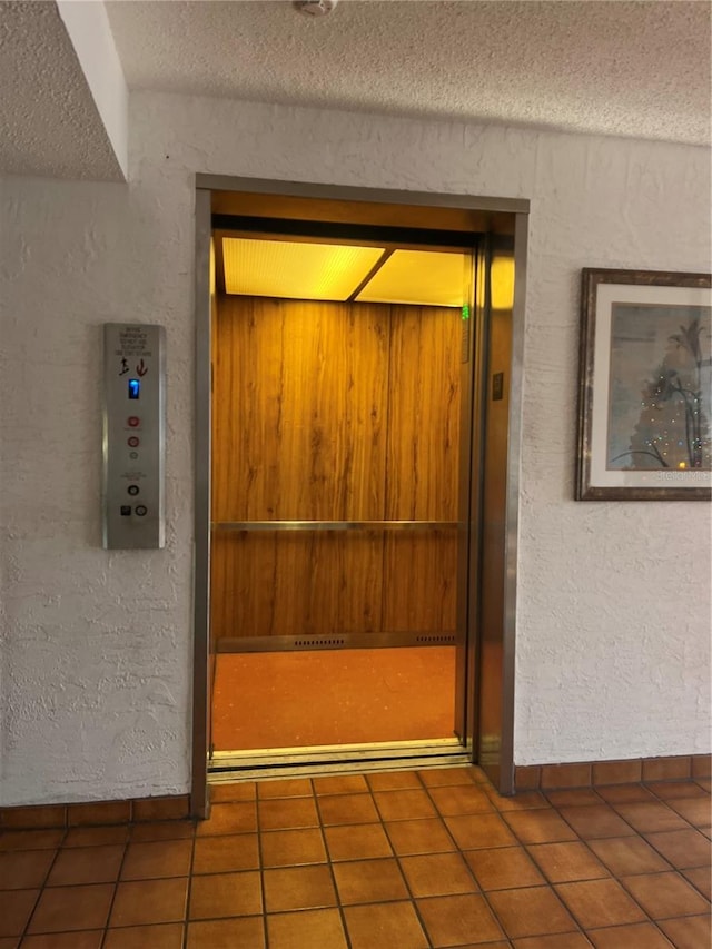 room details with a textured ceiling and elevator