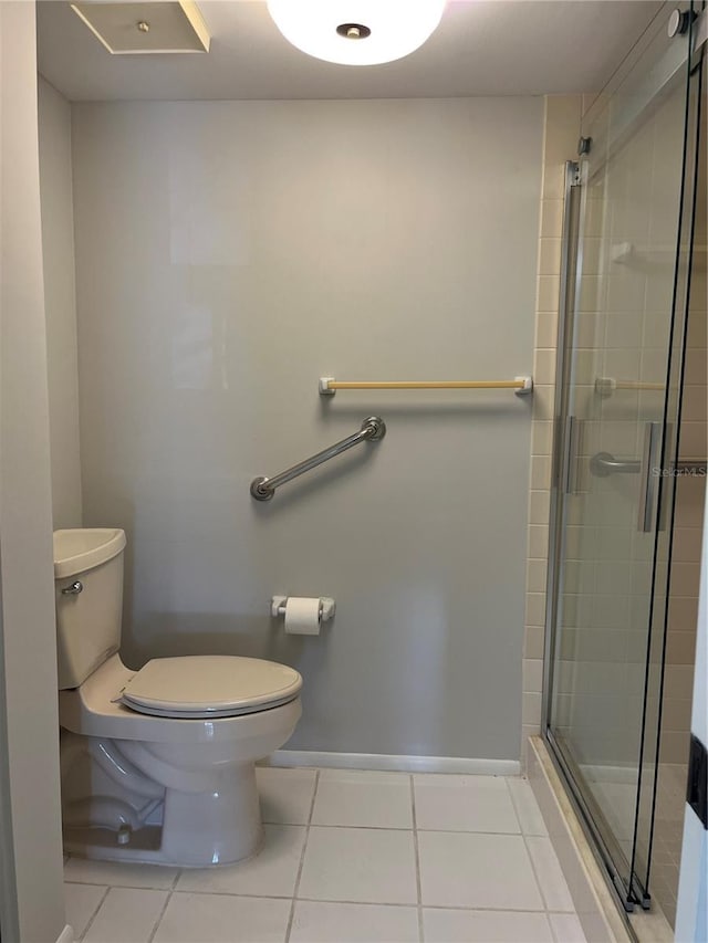 bathroom featuring tile patterned floors, walk in shower, and toilet