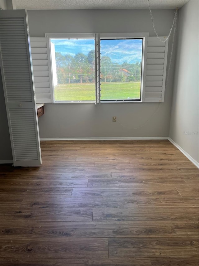 unfurnished room featuring dark hardwood / wood-style floors