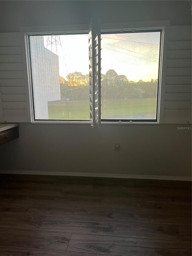 unfurnished room with dark hardwood / wood-style floors