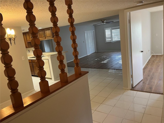 hall with light tile patterned floors and a textured ceiling