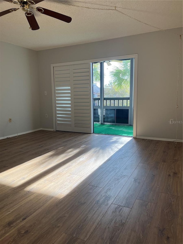 empty room with ceiling fan, a textured ceiling, and hardwood / wood-style flooring