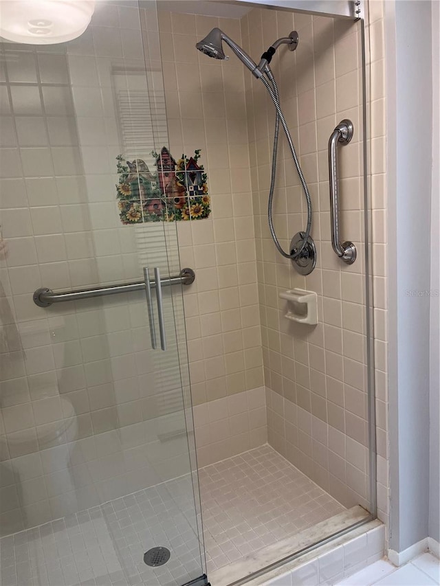 bathroom with a shower with shower door