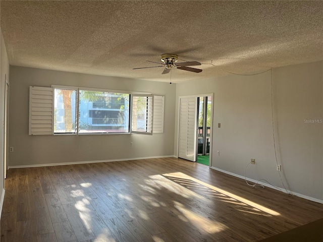 unfurnished room featuring a textured ceiling, ceiling fan, and dark hardwood / wood-style floors