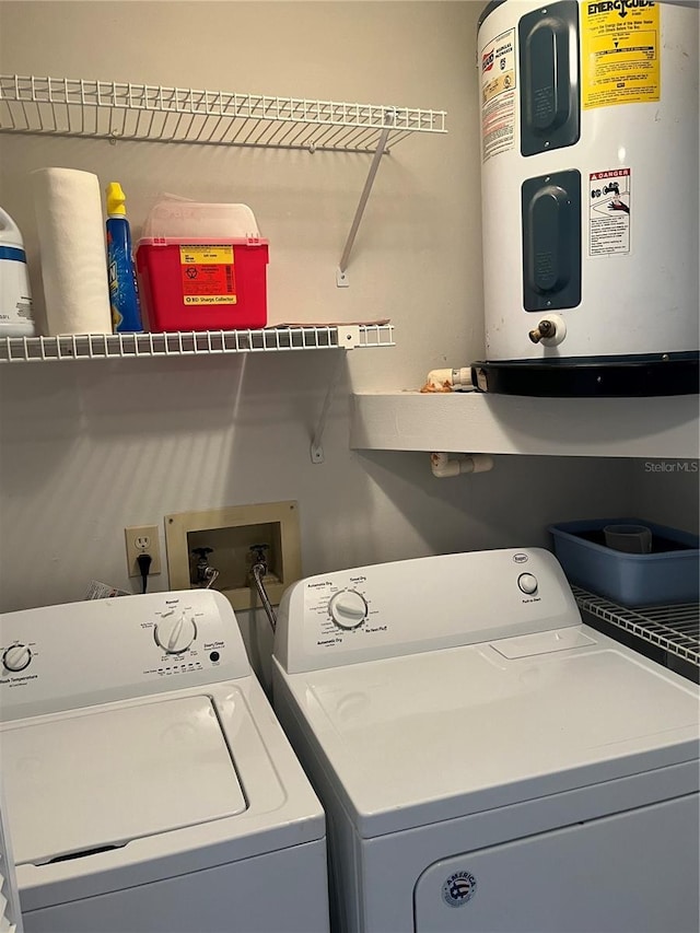 washroom featuring washing machine and dryer and electric water heater