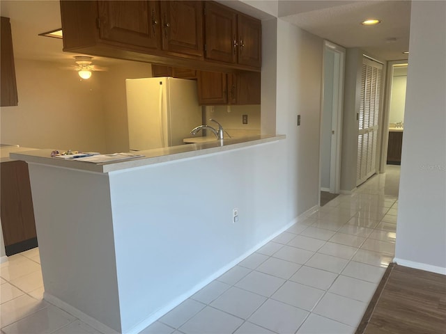 2593 Countryside Blvd Unit 7213, Clearwater, FL 33761 - kitchen featuring freestanding refrigerator, light countertops, light tile patterned floors, and ceiling fan