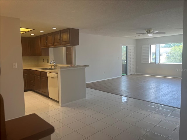 2593 Countryside Blvd Unit 7213, Clearwater, FL 33761 - kitchen with white dishwasher, light tile patterned flooring, ceiling fan, a peninsula, and open floor plan