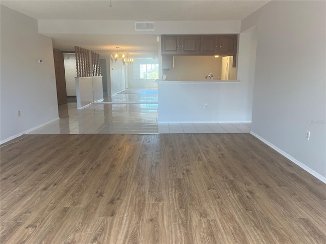 2593 Countryside Blvd Unit 7213, Clearwater, FL 33761 - unfurnished living room featuring a chandelier and wood finished floors
