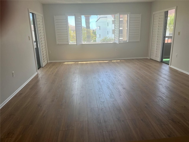 2593 Countryside Blvd Unit 7213, Clearwater, FL 33761 - empty room featuring dark wood-style floors and plenty of natural light