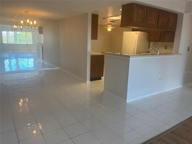 2593 Countryside Blvd Unit 7213, Clearwater, FL 33761 - kitchen with freestanding refrigerator, light tile patterned flooring, a chandelier, light countertops, and ceiling fan