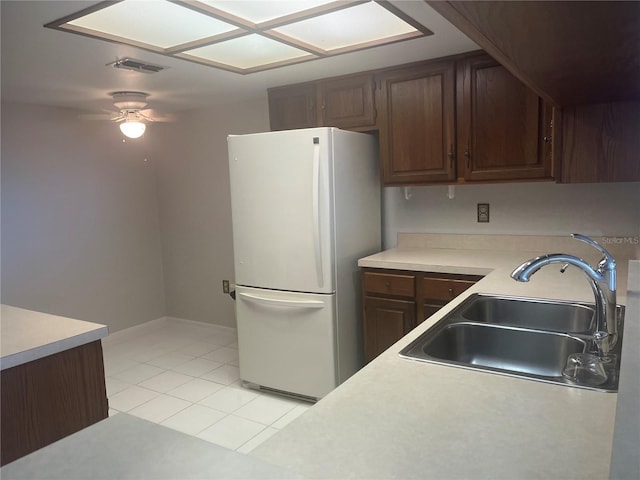2593 Countryside Blvd Unit 7213, Clearwater, FL 33761 - kitchen with freestanding refrigerator, light countertops, a ceiling fan, light tile patterned floors, and dark brown cabinetry