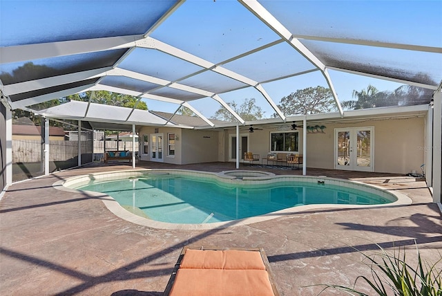 view of pool featuring ceiling fan, french doors, a lanai, an in ground hot tub, and a patio