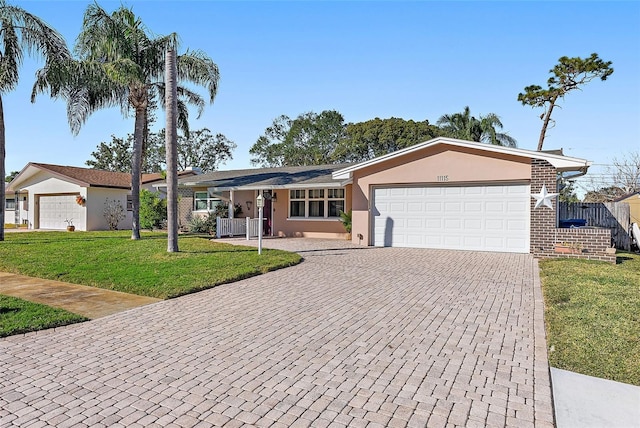 single story home featuring covered porch, a garage, and a front lawn