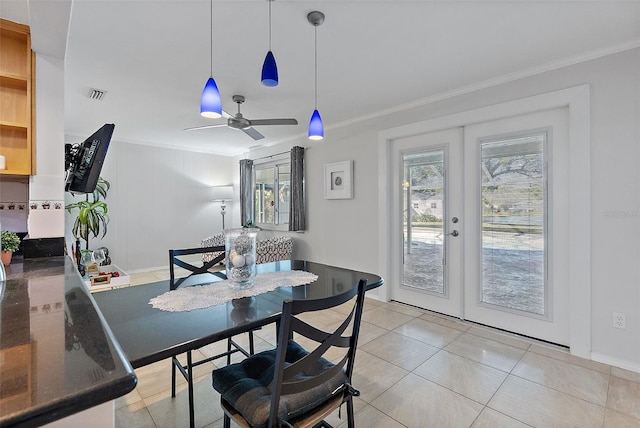 dining room featuring ceiling fan, light tile patterned floors, crown molding, and french doors