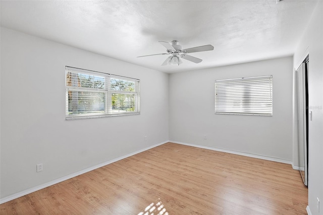 spare room with light hardwood / wood-style flooring and ceiling fan