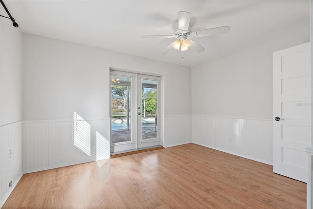 spare room with ceiling fan and light hardwood / wood-style flooring