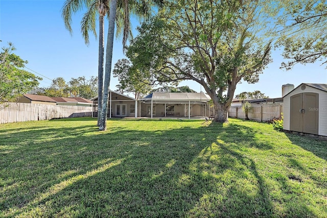 view of yard featuring a shed and a lanai