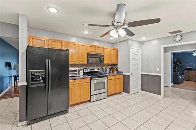 kitchen featuring black appliances, ceiling fan, light tile patterned floors, and backsplash