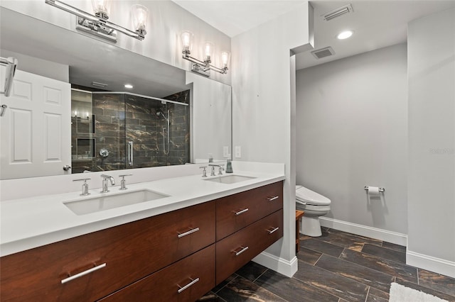 bathroom with vanity, an enclosed shower, and toilet