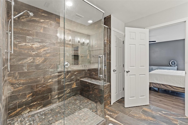 bathroom featuring a shower with door