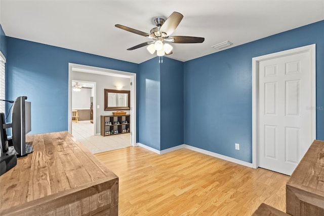 office with ceiling fan and light hardwood / wood-style floors