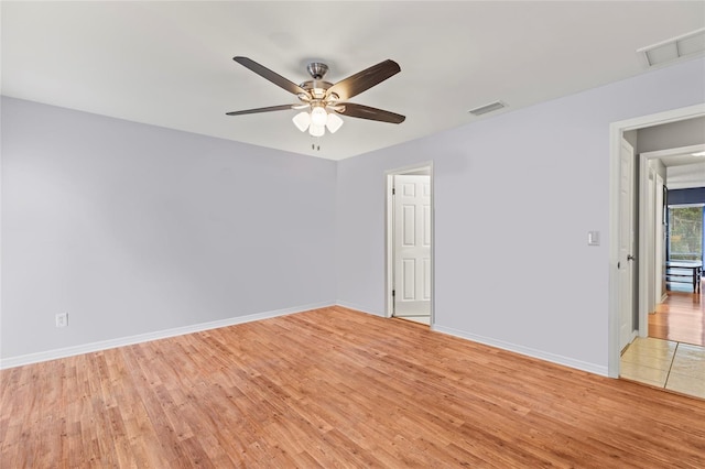 empty room featuring ceiling fan and light hardwood / wood-style flooring